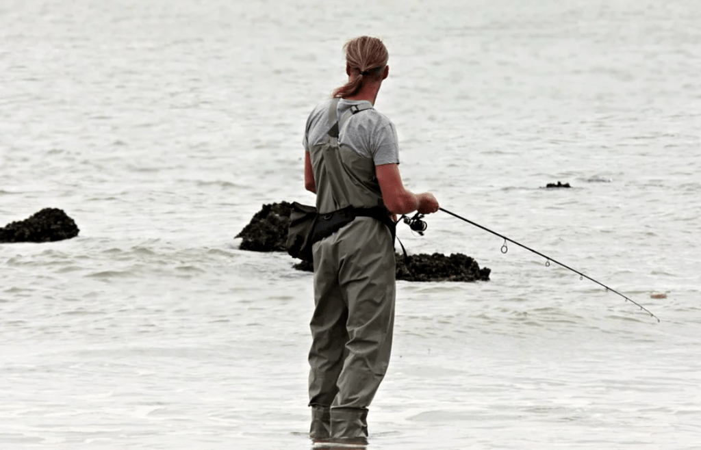 Man with a fishing license, fishing in the surf