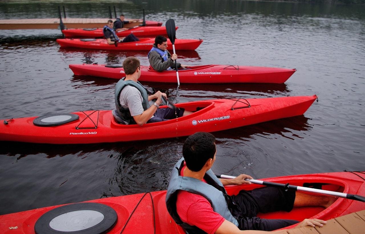 People riding red kayaks