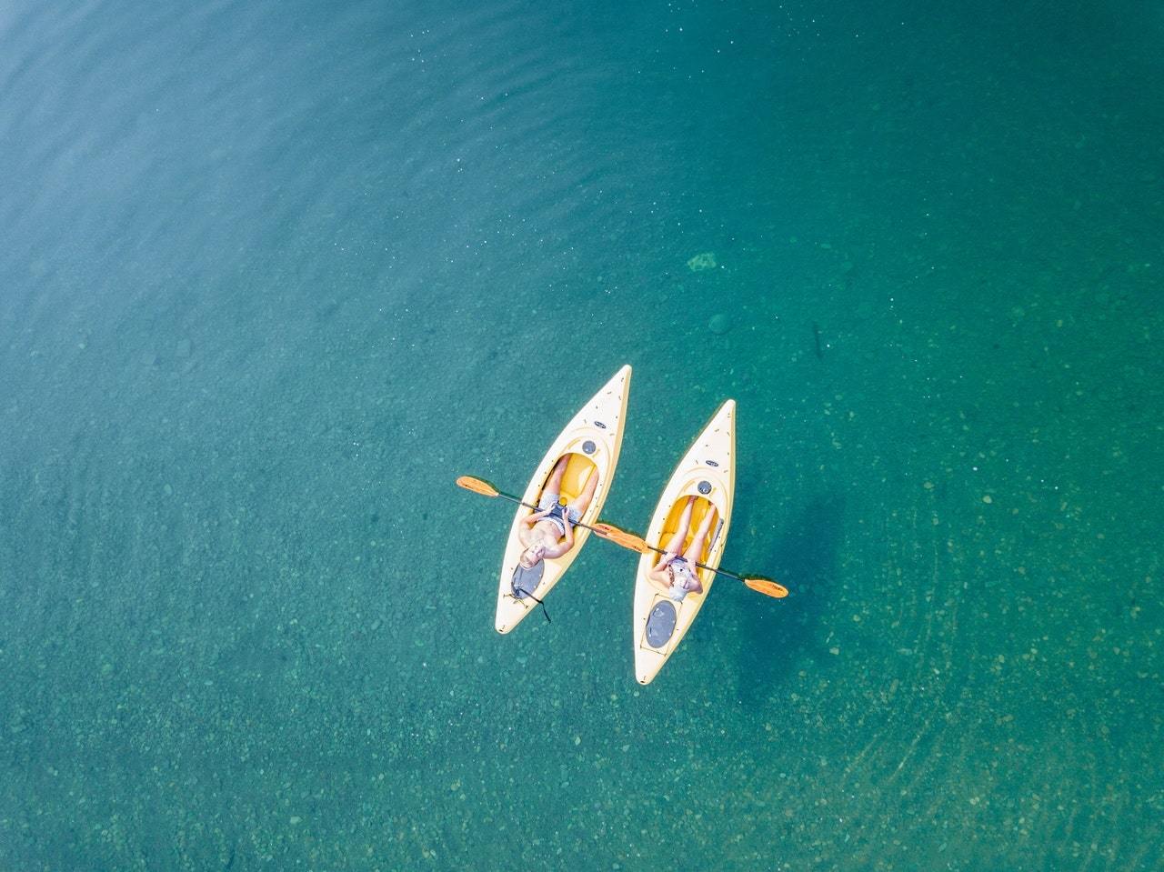 Two people kayaking on body of water
