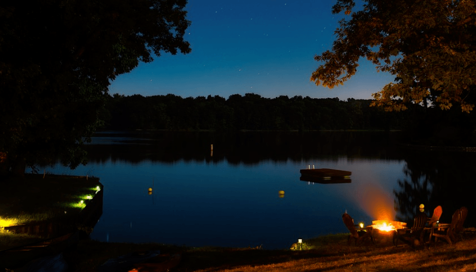 Lake Sarah, Illinois, showing camp fire in fishing camp. Fishing licenses in Illinois.